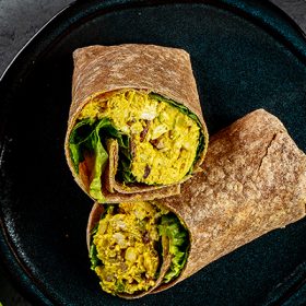 curry chicken salad wrap cut in half served